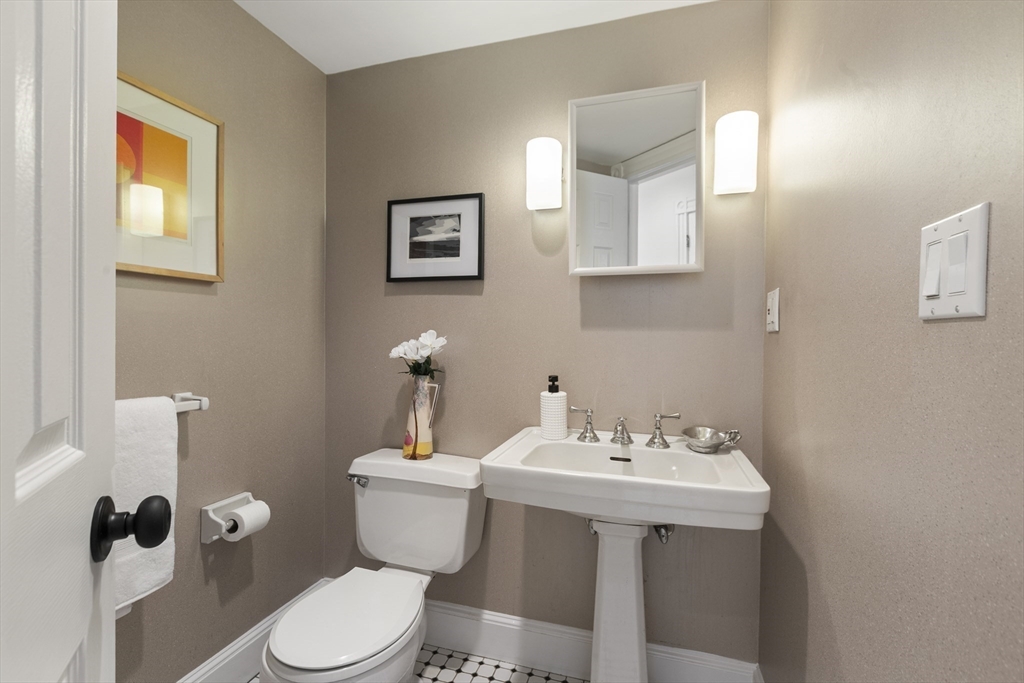 169 Walnut Street, Unit 2 Boston, MA 02122 - Photo 14 of 42 a bathroom with a sink mirror and toilet