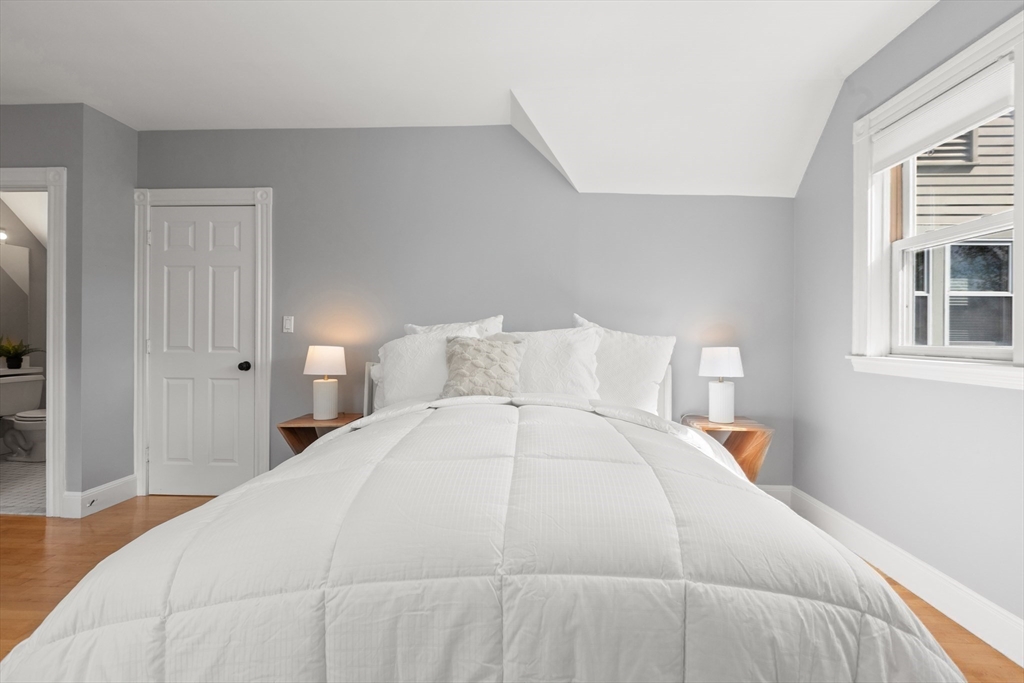 169 Walnut Street, Unit 2 Boston, MA 02122 - Photo 16 of 42 a large white bed in a white room