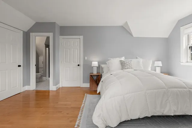 a bedroom with a bed and a potted plant