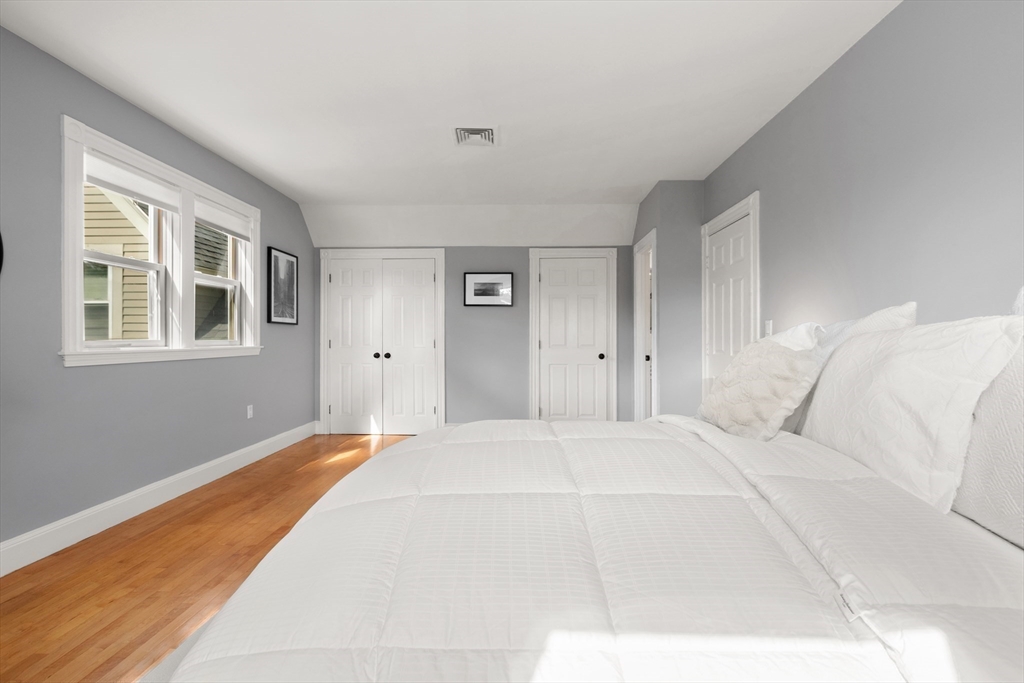 169 Walnut Street, Unit 2 Boston, MA 02122 - Photo 19 of 42 a large white bed in a white room