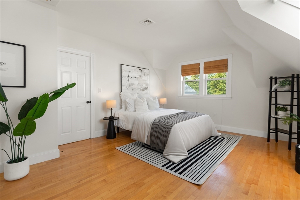 169 Walnut Street, Unit 2 Boston, MA 02122 - Photo 23 of 42 a bedroom with a bed and a potted plant