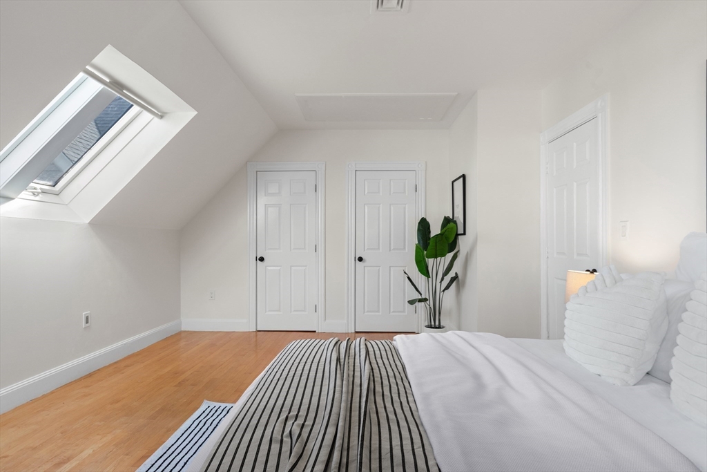 169 Walnut Street, Unit 2 Boston, MA 02122 - Photo 24 of 42 a bedroom with a bed and a window