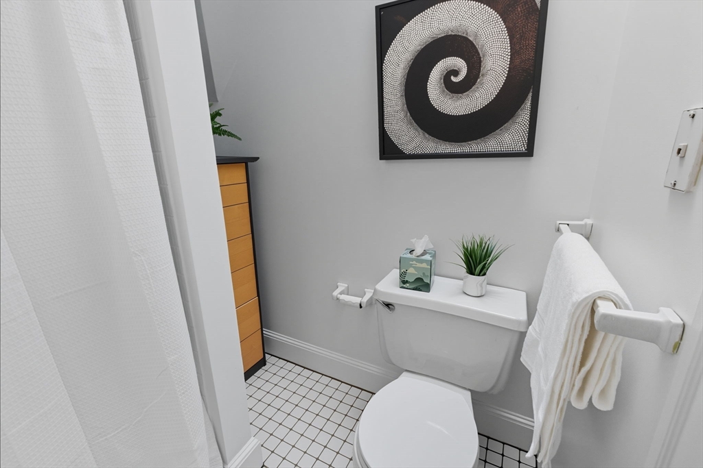 169 Walnut Street, Unit 2 Boston, MA 02122 - Photo 28 of 42 a white toilet sitting next to a small bathroom