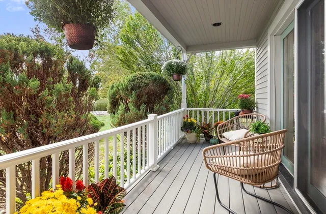 a view of a house with a yard and lawn chairs with a fire pit