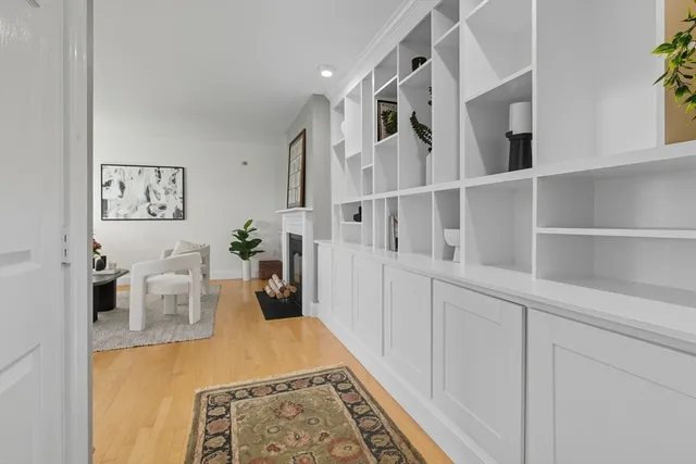 a living room with furniture a potted plant and a fireplace