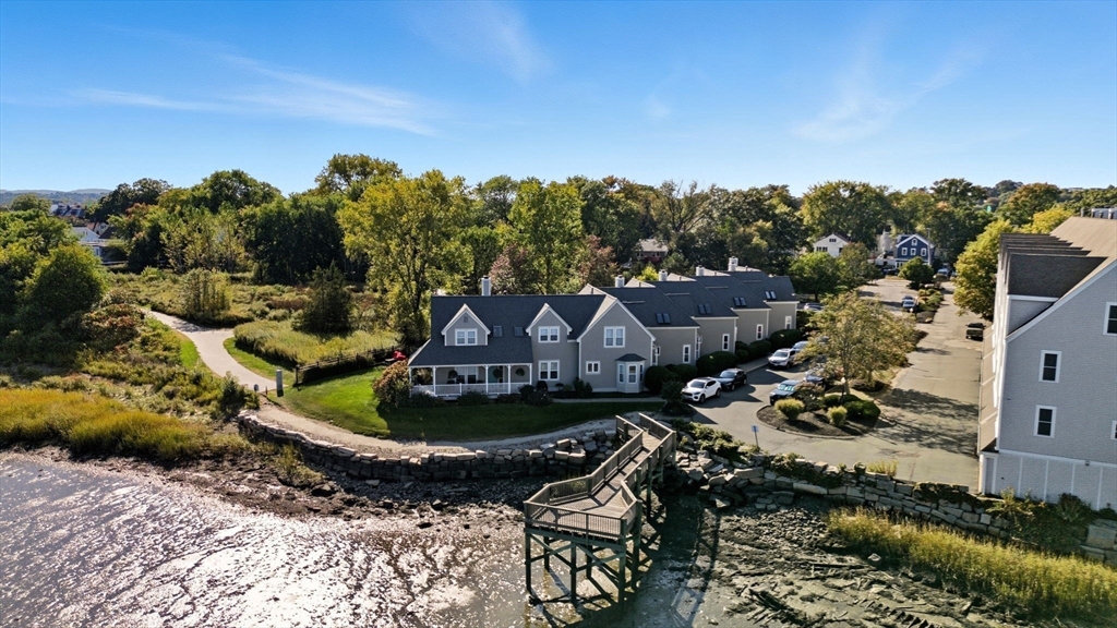 169 Walnut Street, Unit 2 Boston, MA 02122 - Photo 36 of 42 a view of a house with a big yard and large trees