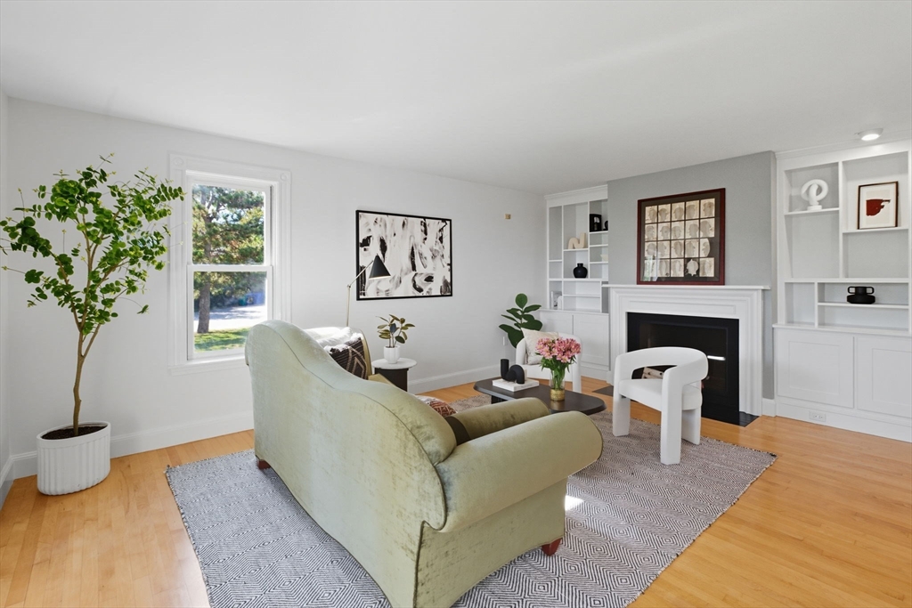 169 Walnut Street, Unit 2 Boston, MA 02122 - Photo 6 of 42 a living room with furniture a potted plant and a fireplace