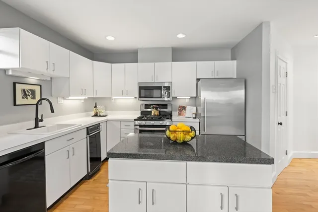 a bathroom with a sink mirror and toilet
