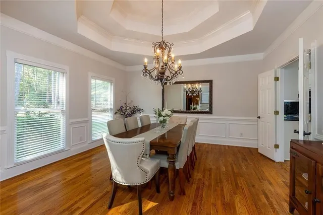 a view of a dining room with furniture and a chandelier