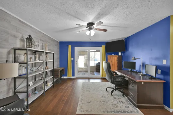 a view of a workspace with furniture and a window