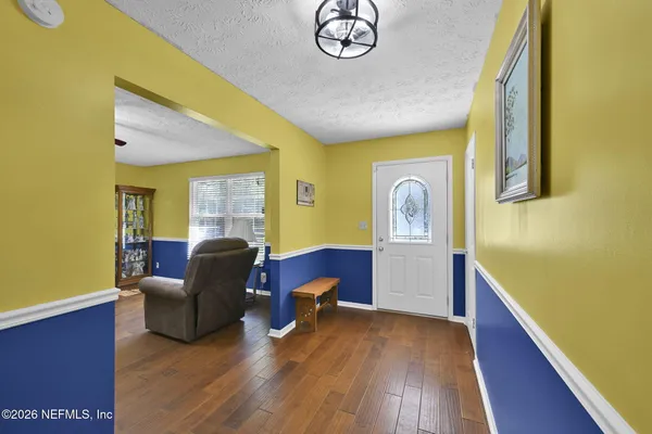 a bedroom with furniture and a window