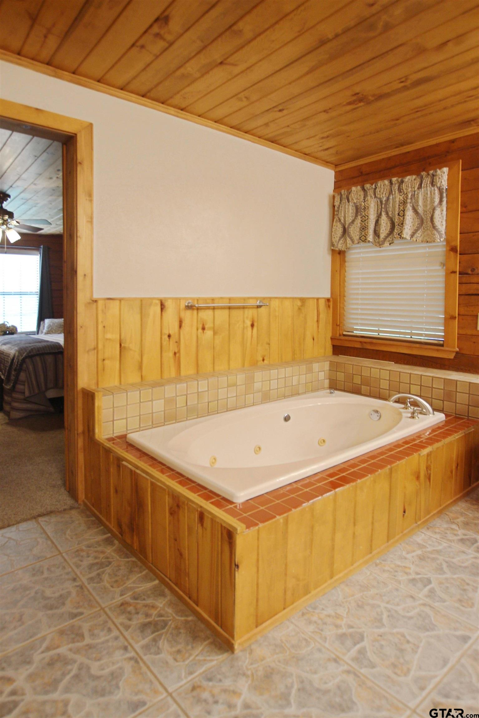 782 Rosie Wady Road Gladewater, TX 75647 - Photo 19 of 48 a spacious bathroom with a tub and window