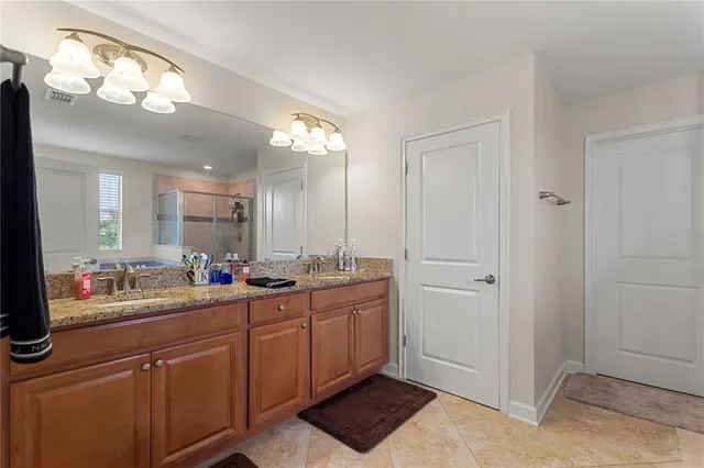 a bathroom with a double vanity sink and a mirror