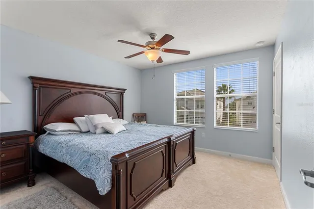 a bedroom with a bed and a large window