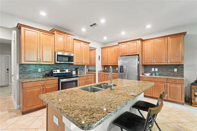 a kitchen with stainless steel appliances granite countertop sink microwave and stove