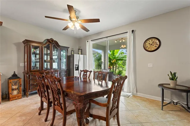 a dining room with furniture a rug and a large window
