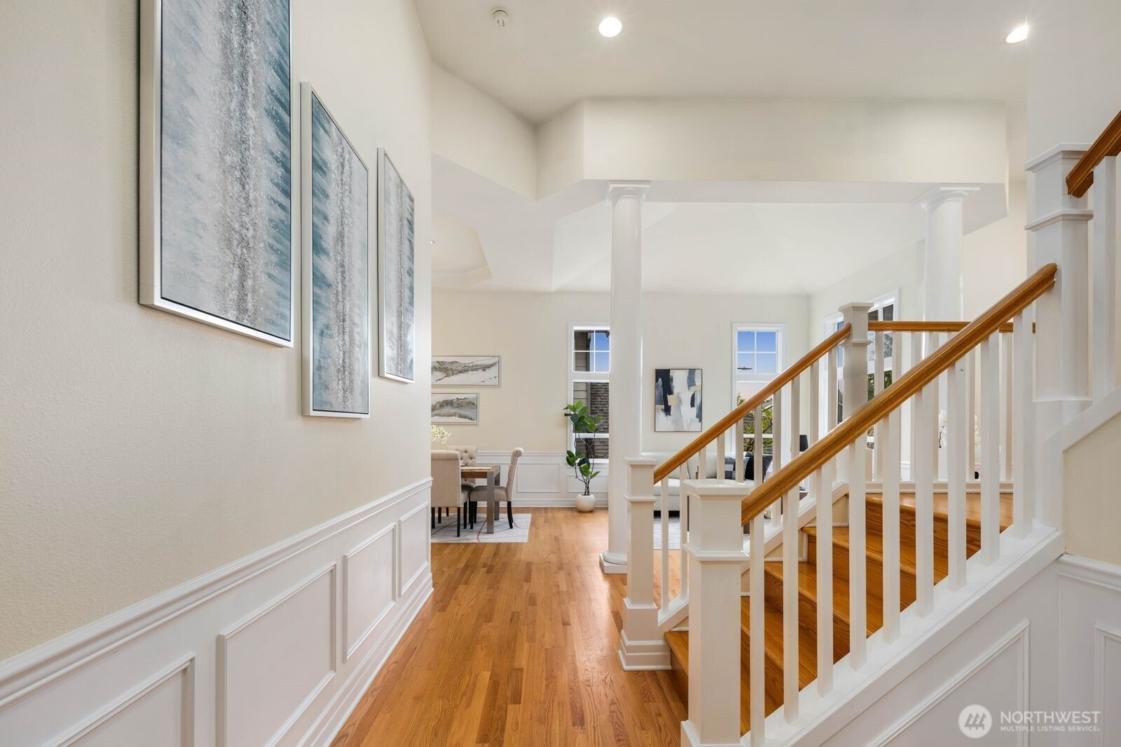 3429 Lincoln Avenue Northeast Renton, WA 98056 - Photo 11 of 40 a view of staircase with lots of frames on wall and wooden floor