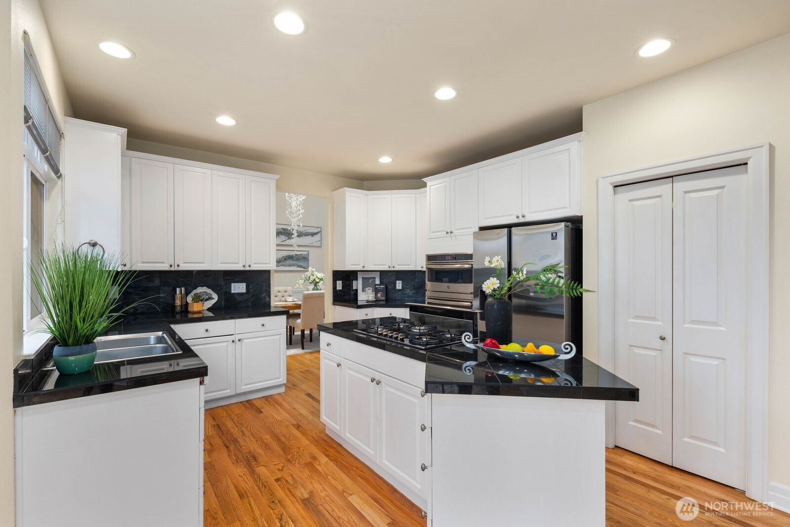 3429 Lincoln Avenue Northeast Renton, WA 98056 - Photo 14 of 40 a kitchen with stainless steel appliances kitchen island granite countertop a stove a sink and a refrigerator