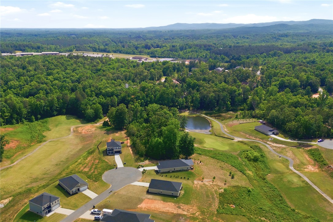 412 Chadwick Lane Walhalla, SC 29691 - Photo 34 of 37 Overlook this expansive residential development featuring homes nestled amidst lush forests and a scenic pond with a golf course.
