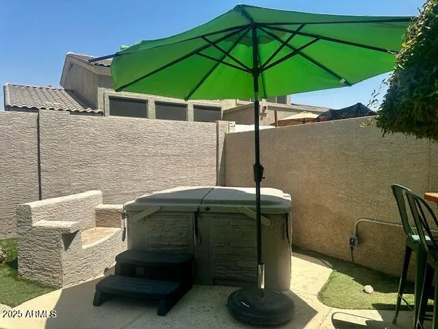 a roof deck with table and chairs under an umbrella