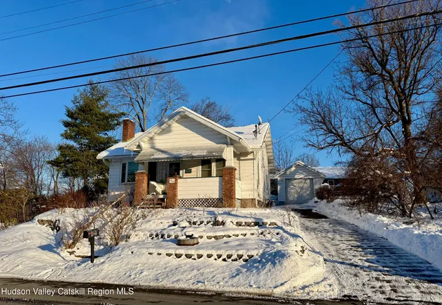 a view of a house with a snow in the yard