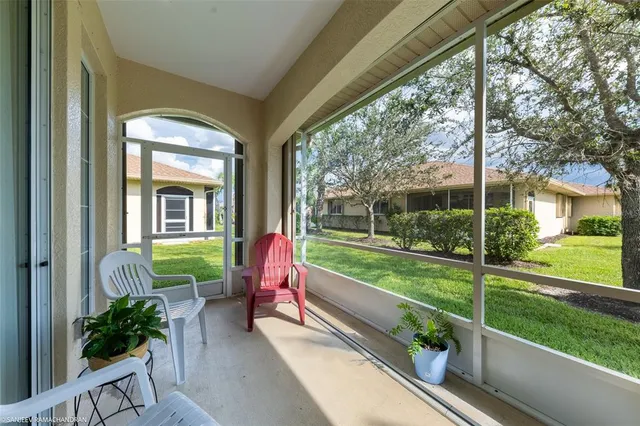 a view of a porch with furniture and garden