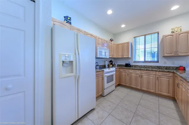 a kitchen with a refrigerator and cabinets