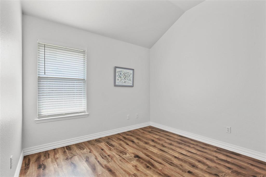 5961 Cheyenne Way Frisco, TX 75034 - Photo 26 of 33 Interior room featuring a vaulted ceiling and wood-finish flooring