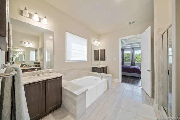 a large white kitchen with a sink and dish washer