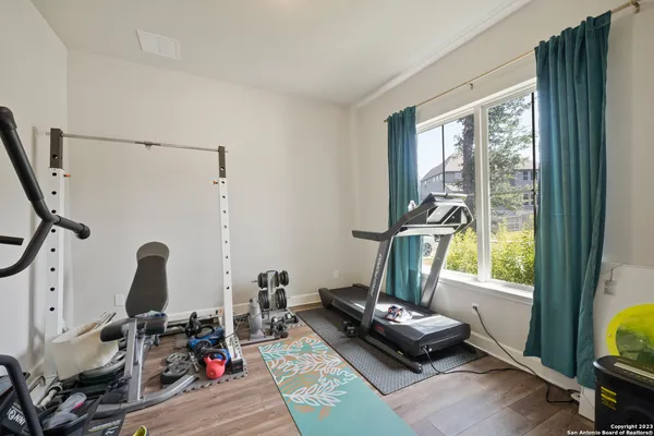 a room with gym equipment and a large window