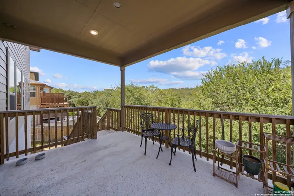 a view of a chairs and table in the balcony