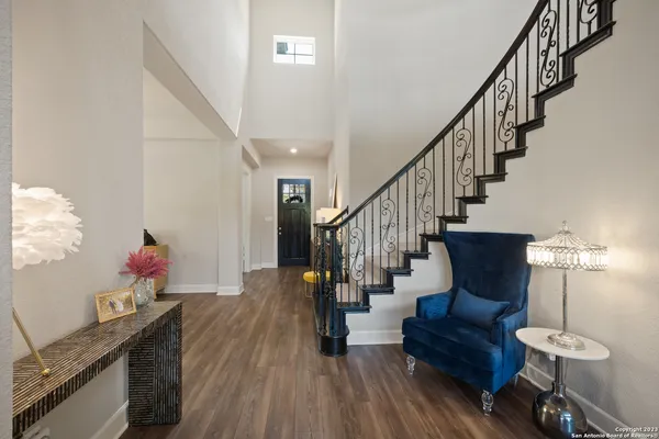 a view of entryway and hall with wooden floor