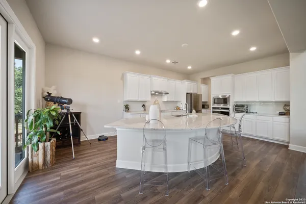 a view of kitchen with sink and center island