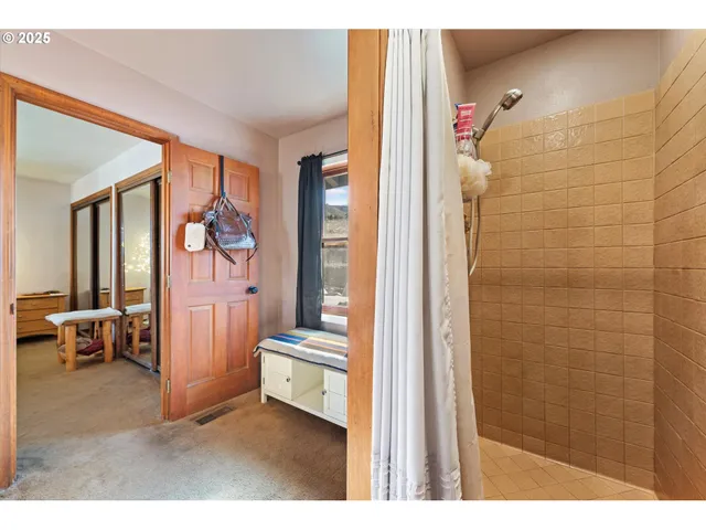 a bedroom with a large bed and a large window