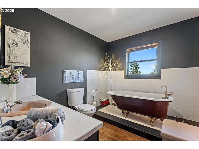 a bedroom with a bed window and a flat screen tv