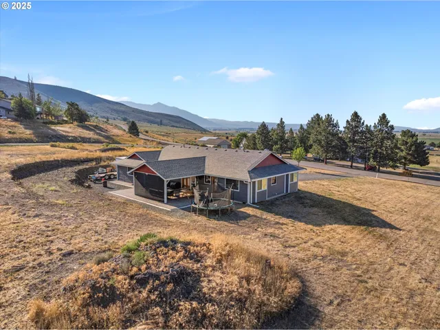 a view of a house with backyard porch and sitting area