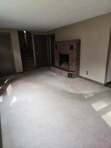 a view of an empty room with fire place