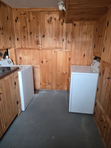 a view of a utility room with wooden walls