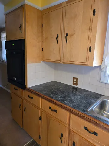 a kitchen with granite countertop white cabinets and granite counter tops