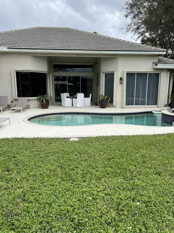 a view of a house with a swimming pool and a porch
