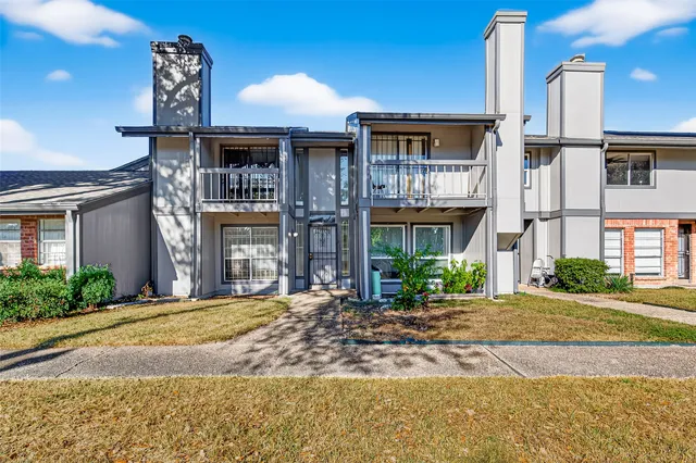 a front view of a house with yard and garage