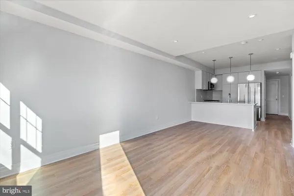 a view of an empty room with cabinet and a window