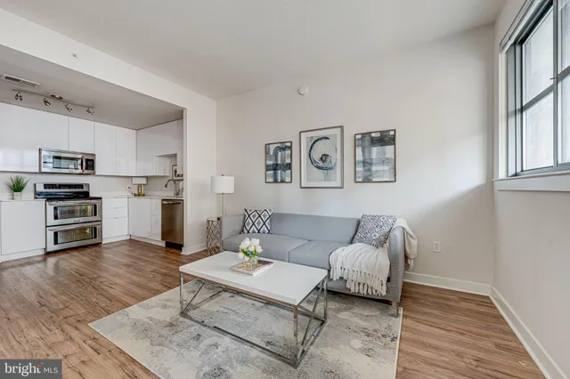 a living room with furniture and kitchen view
