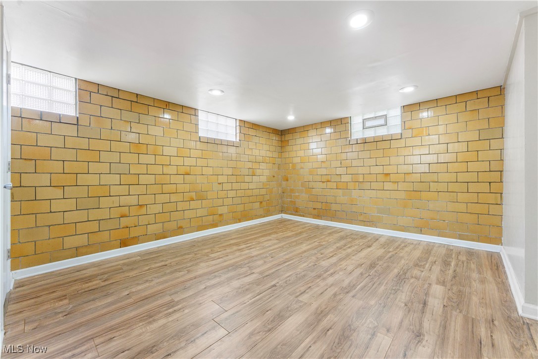 1703 Ferndale Road Northwest Canton, OH 44709 - Photo 25 of 34 Basement with wood finished floors, recessed lighting, and plenty of natural light