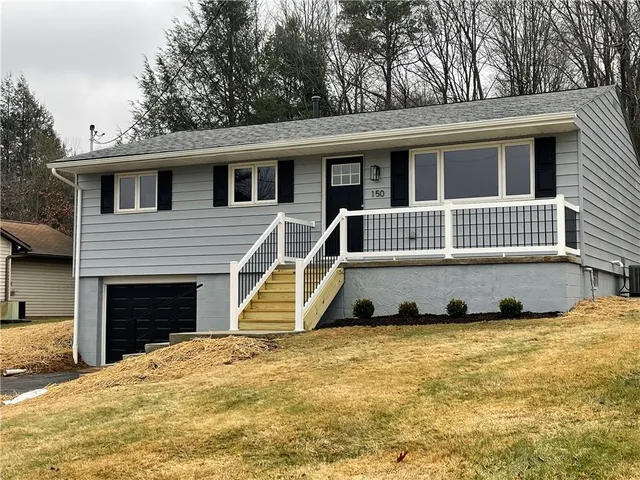 a front view of a house with a yard