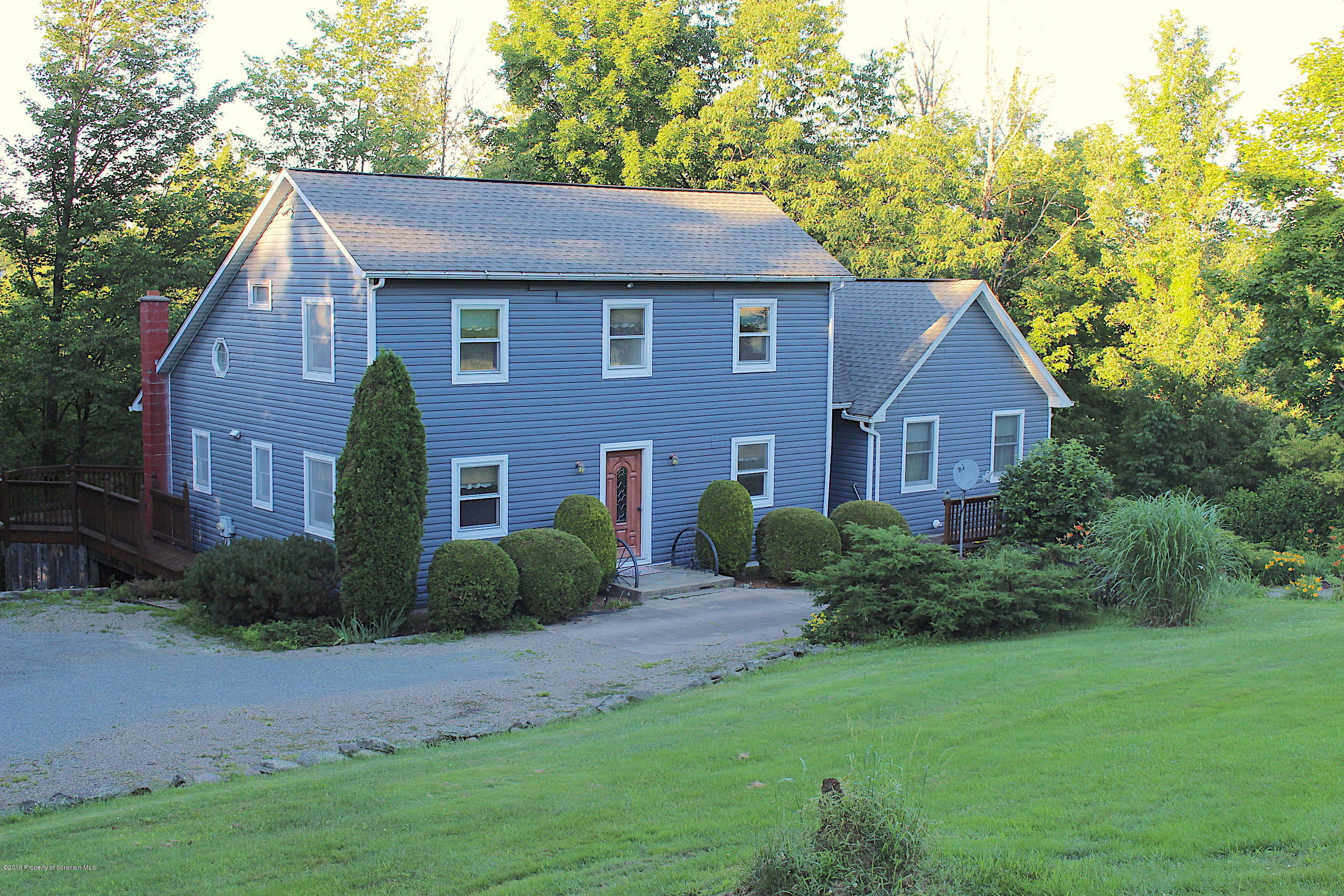 a aerial view of a house next to a yard