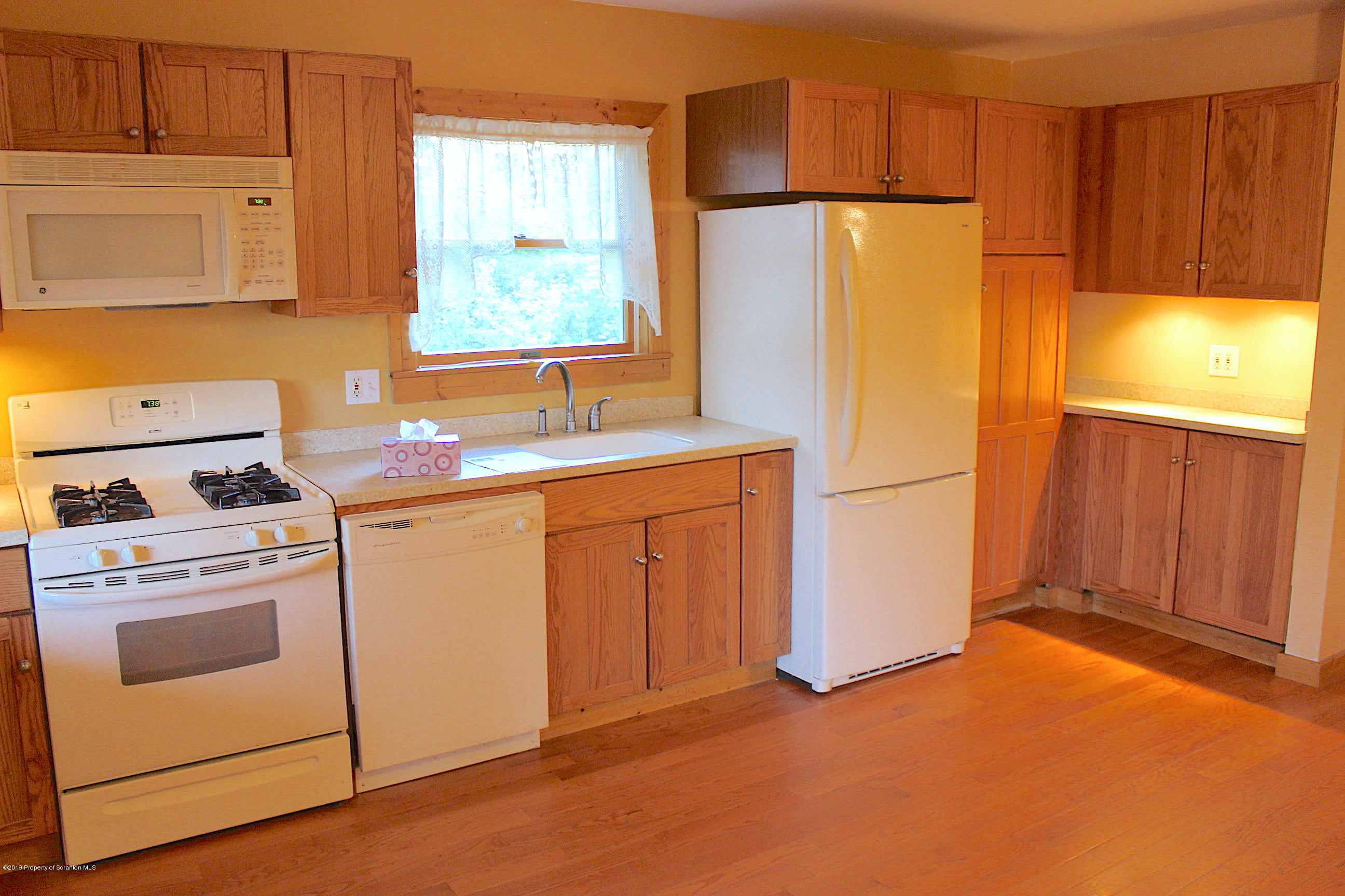1603 Oak Ridge Road Mehoopany, PA 18629 - Photo 23 of 52 a kitchen with a refrigerator sink stove and cabinets