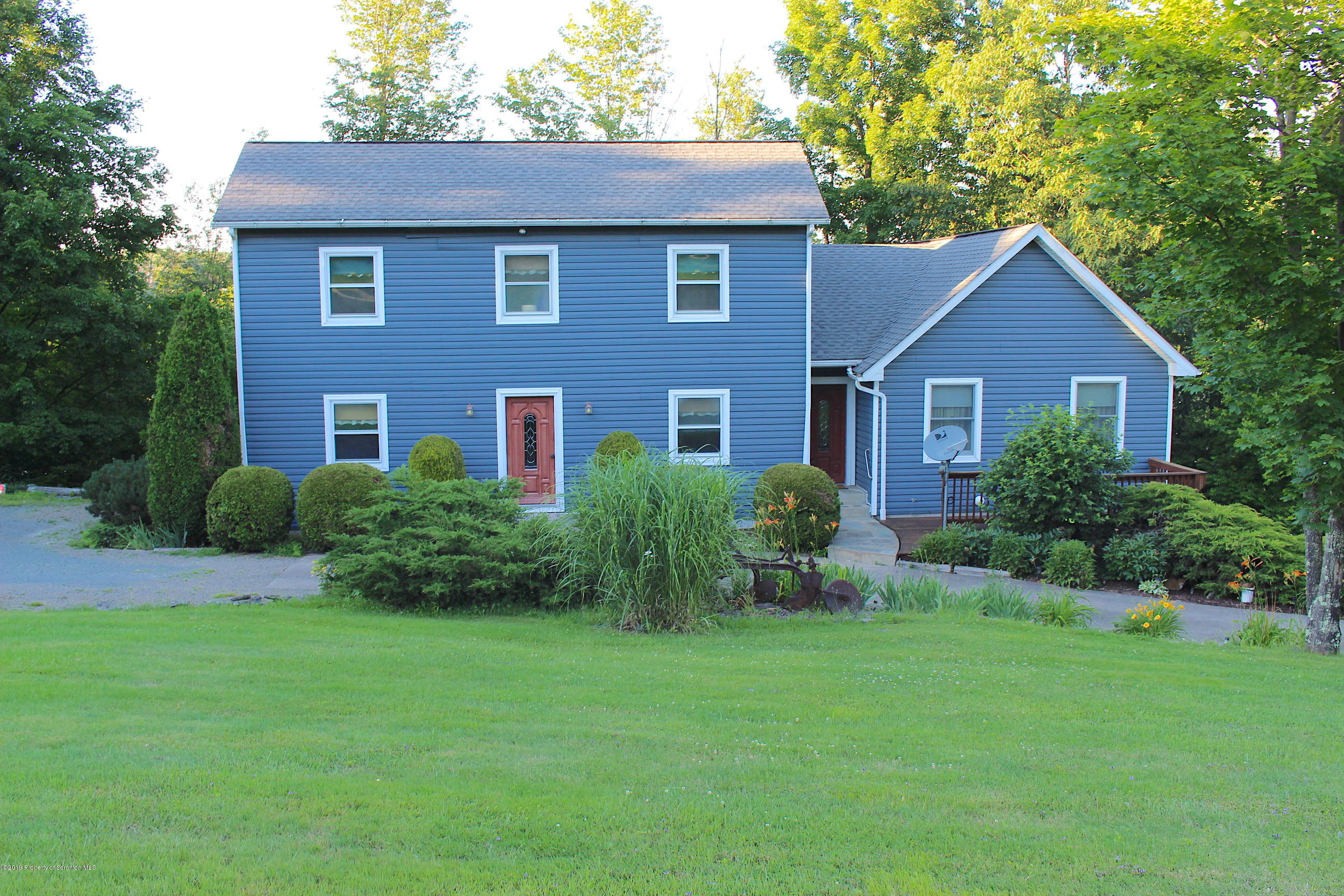 1603 Oak Ridge Road Mehoopany, PA 18629 - Photo 49 of 52 a front view of a house with a yard