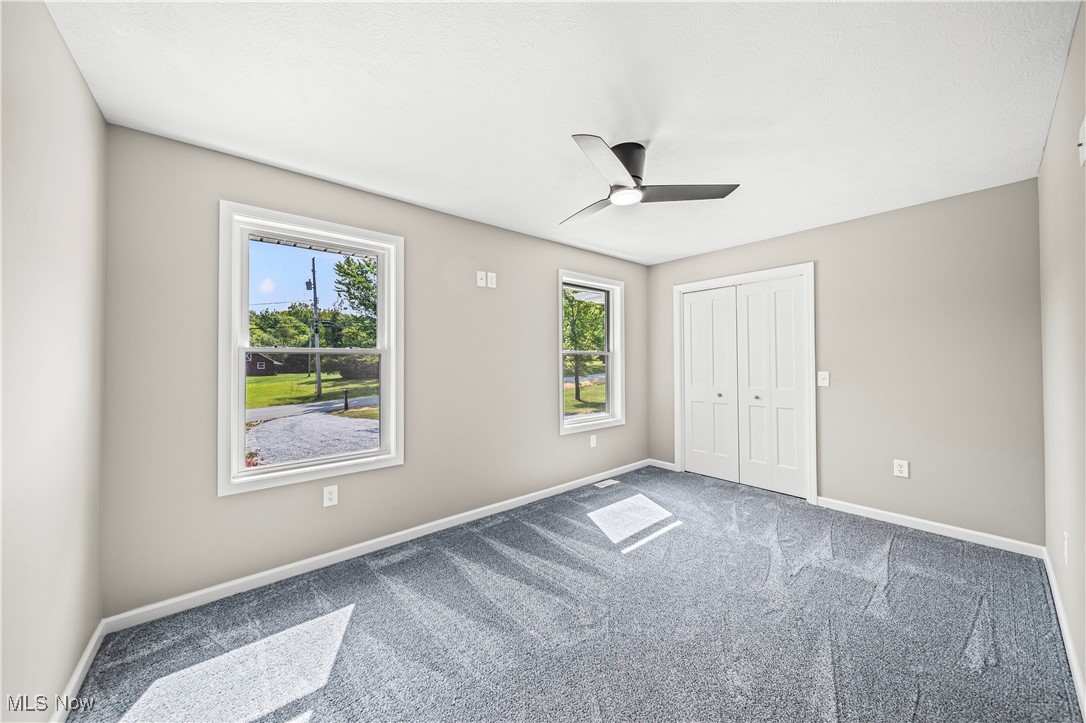 2049 Barnum Road Geneva, OH 44041 - Photo 19 of 33 Unfurnished bedroom featuring ceiling fan, a closet, and carpet