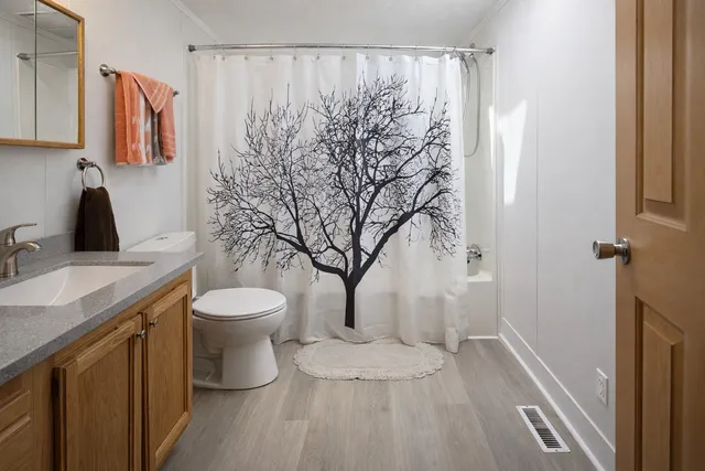 a bathroom with a toilet sink and shower